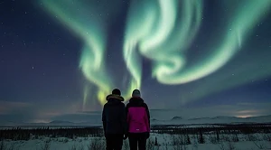 A couple looking at the northern lights at night. (Generated with AI)