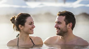 A couple looking at each other sitting in hot springs. (Generated with AI)