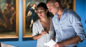 A couple looking at art in a museum. (Generated with AI)