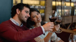 A couple is looking at their glasses of wine at a tasting. (Generated with AI)
