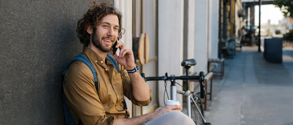 Men smiling and thinking how long should you wait to ask someone out