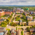 A city view of Ann Arbor, showing houses and green spaces.