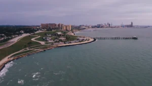 A skyline view of corpus christi with water and the beach.