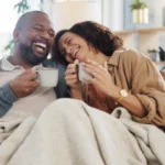 Couple on the couch laughing and having a good time