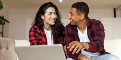 A couple sitting on the couch having a conversation